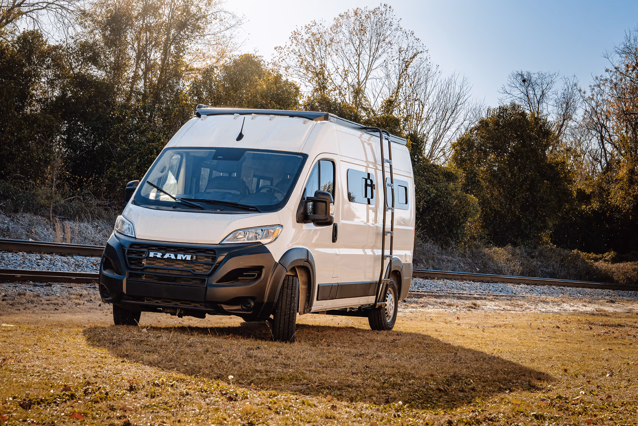 A finished RAM campervan near railroad tracks